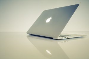Closed silver laptop on a plain background