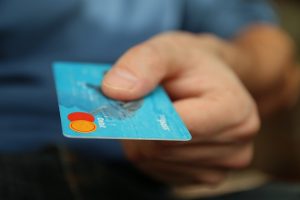 Hand holding out a bank card