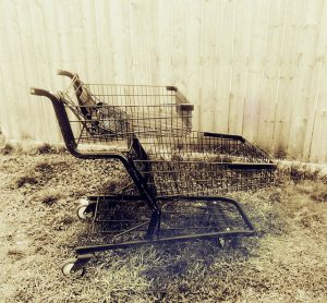 Abandoned shopping trolleys left on rough ground