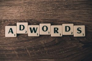 Lettered tiles spelling Adwords on a wooden surface