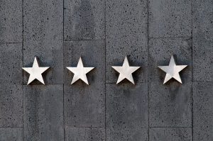 Four star shapes mounted on a concrete wall