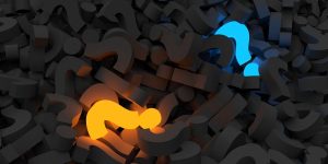 Mass of grey 3D question marks with one orange and one blue standing out