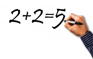 Hand writing the incorrect equation two plus two equals five on a whiteboard