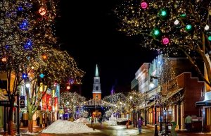 Town street decorated with Christmas lights at night