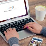 person using google search on a laptop