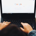 man searches google on his laptop