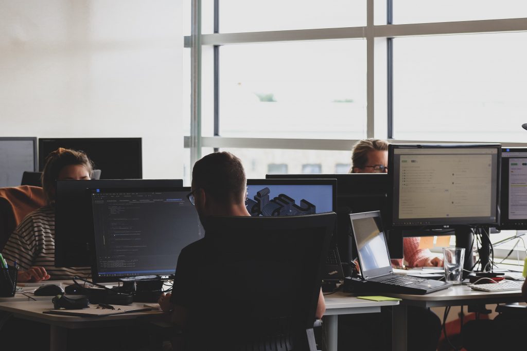 group of people sitting in front of computers